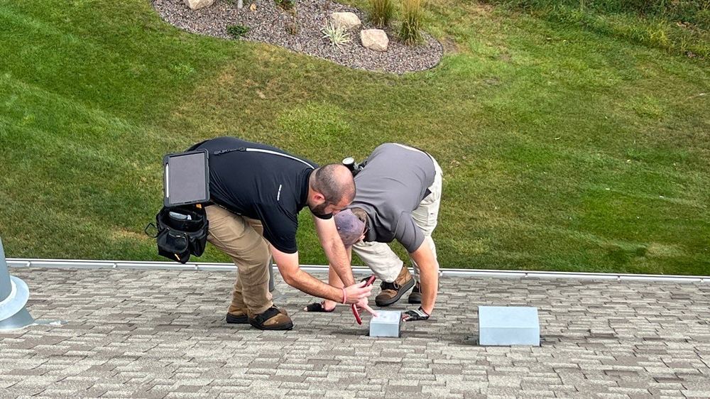 New Line project manager meeting an insurance adjuster on the roof