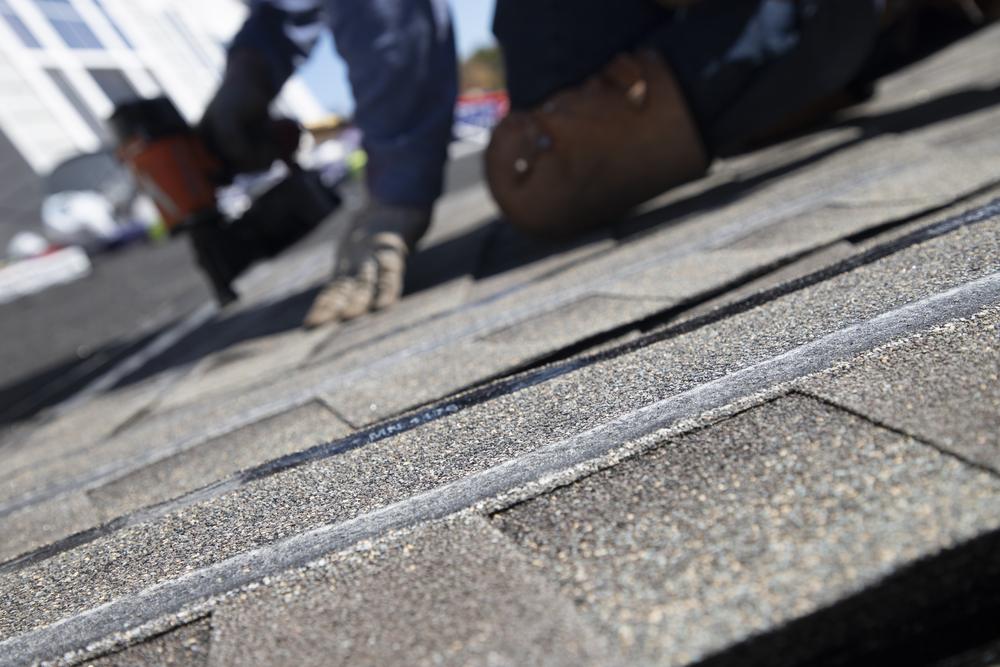 Shingle courses being installed on a townhome roof